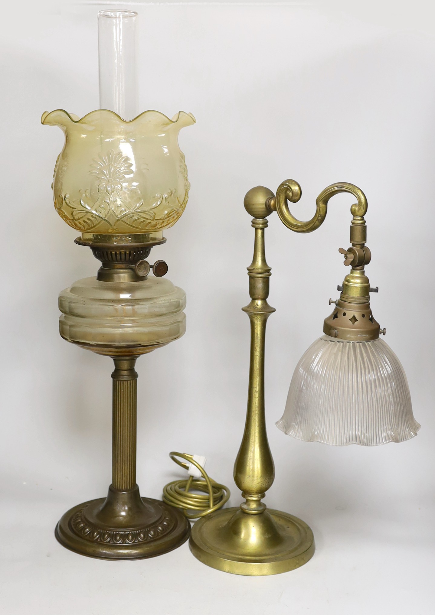 An Edwardian brass desk lamp with glass shade and a Victorian brass columned oil lamp with shade, oil lamp 65cms high